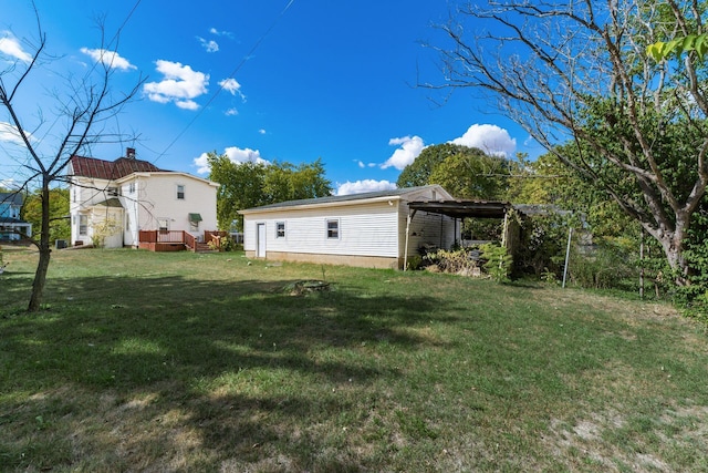 view of yard featuring a carport and a wooden deck