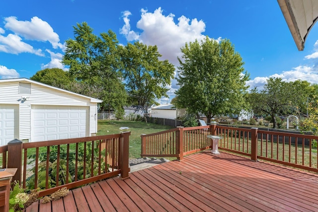 wooden terrace with a yard and a garage