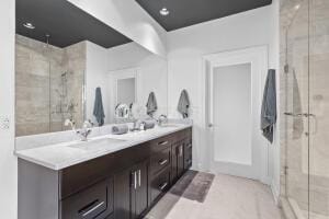 bathroom with vanity and a shower with door