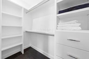 walk in closet featuring dark wood-type flooring