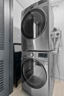 laundry area with stacked washer and clothes dryer