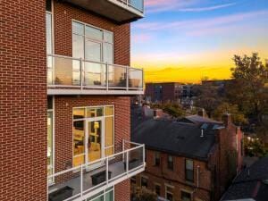 property exterior at dusk with a balcony