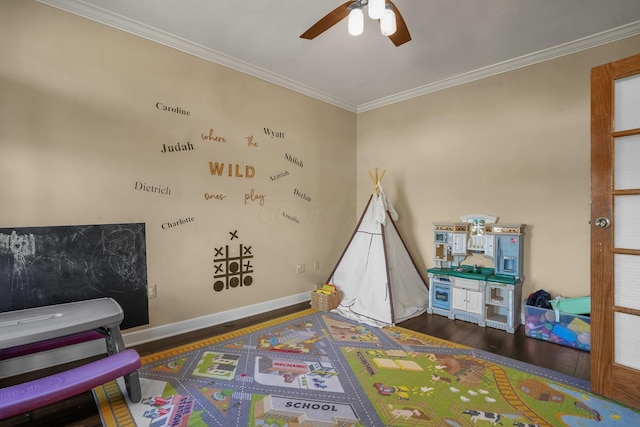 game room featuring crown molding, dark hardwood / wood-style floors, and ceiling fan