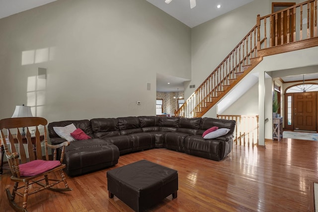 living room featuring wood-type flooring and a high ceiling