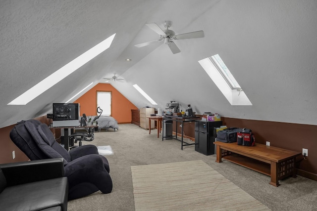 bonus room with ceiling fan, lofted ceiling, light carpet, and a textured ceiling