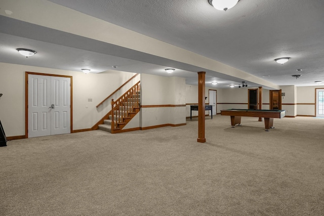 rec room featuring billiards, light colored carpet, and a textured ceiling