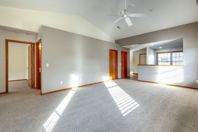 empty room featuring high vaulted ceiling, carpet floors, and ceiling fan