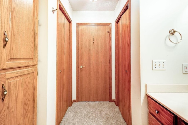 corridor with light colored carpet