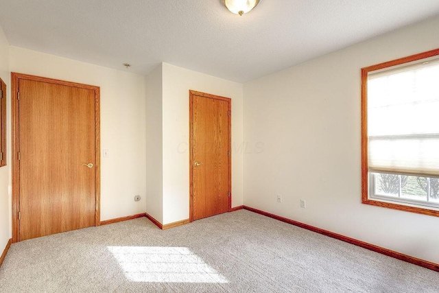 unfurnished bedroom with light carpet and a closet