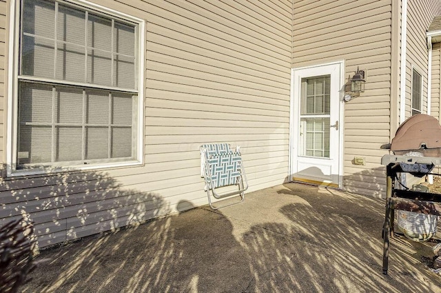 view of exterior entry featuring a patio