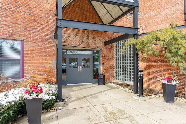 view of exterior entry with french doors and brick siding