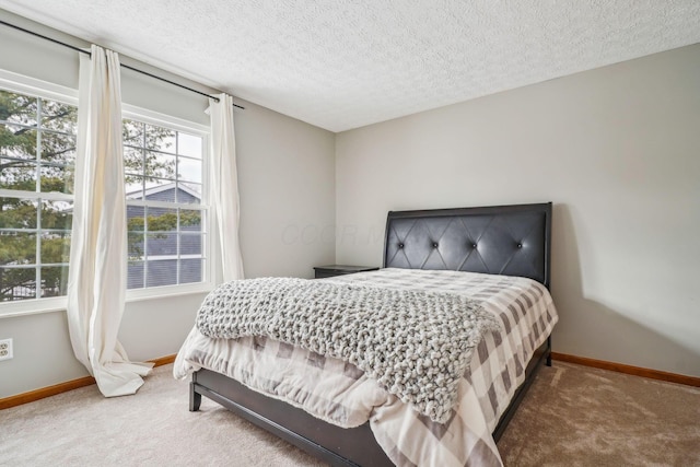 carpeted bedroom featuring a textured ceiling