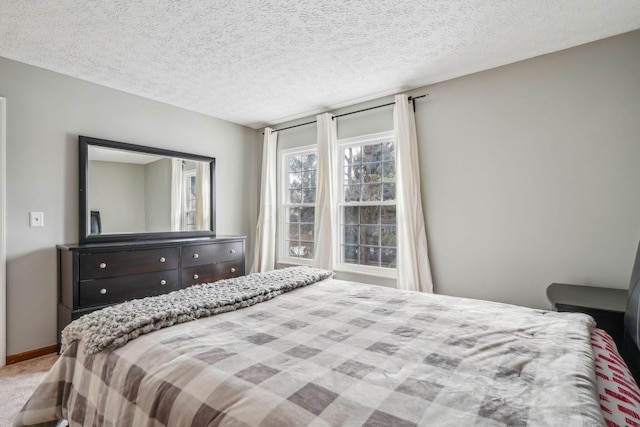 bedroom featuring carpet floors and a textured ceiling