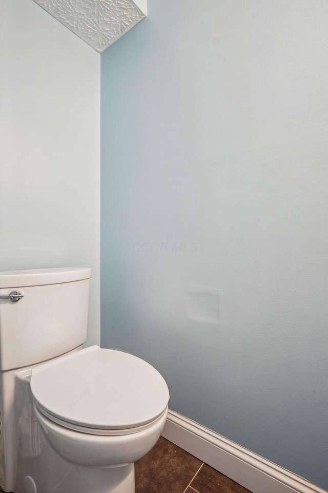 bathroom with tile patterned floors and toilet