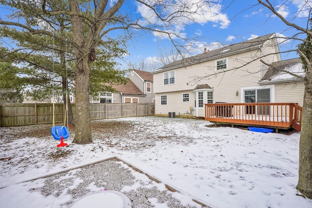 snow covered house with a deck