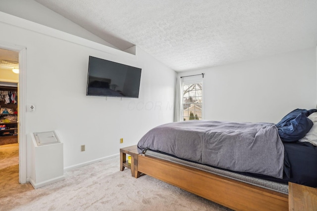 carpeted bedroom with lofted ceiling and a textured ceiling