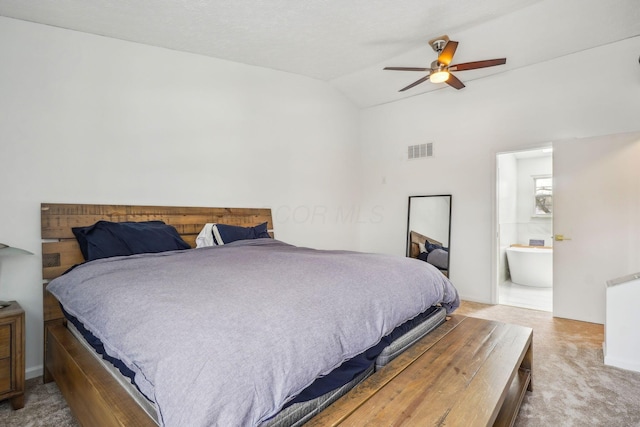 carpeted bedroom with lofted ceiling, ensuite bath, and ceiling fan