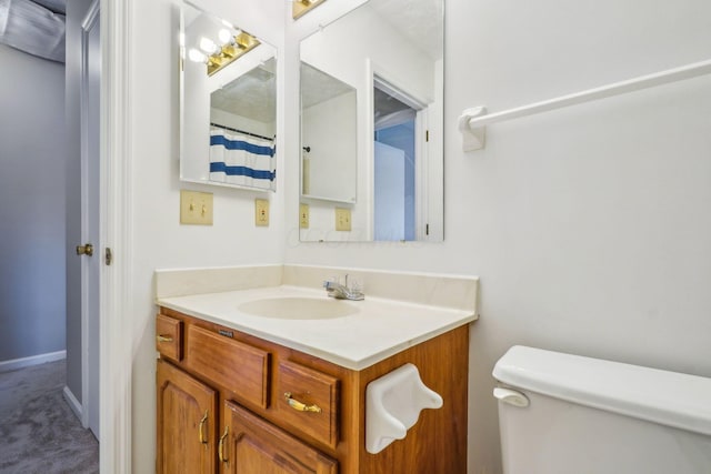 bathroom featuring vanity and toilet