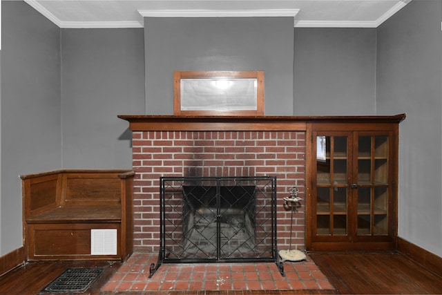 details with crown molding, hardwood / wood-style floors, and a brick fireplace