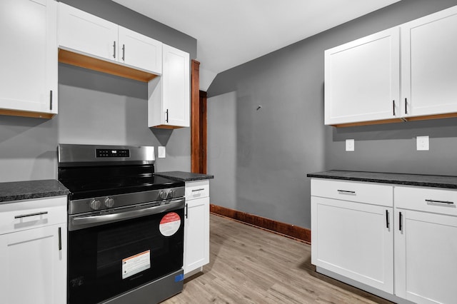 kitchen featuring white cabinets, light hardwood / wood-style floors, and stainless steel range with electric stovetop