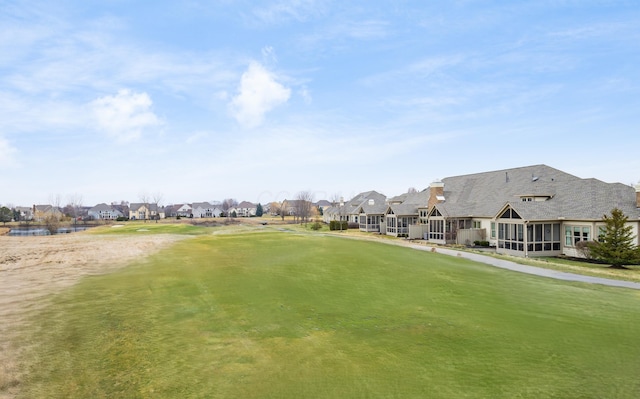 view of community with a yard and a residential view