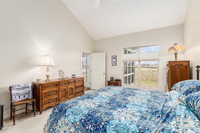 bedroom featuring light carpet, lofted ceiling, and a ceiling fan