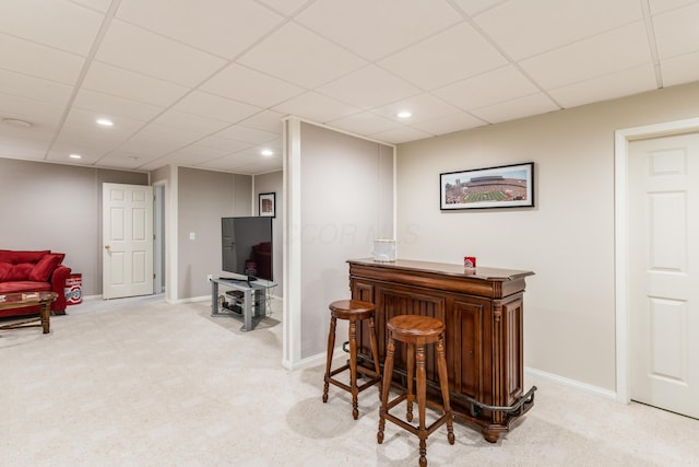 bar with recessed lighting, baseboards, light carpet, and a dry bar