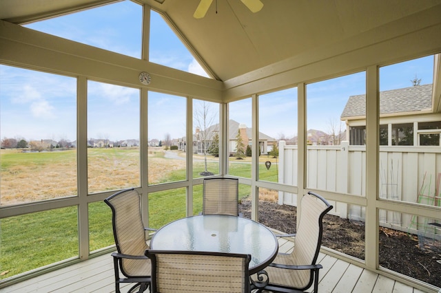 sunroom / solarium featuring lofted ceiling and ceiling fan