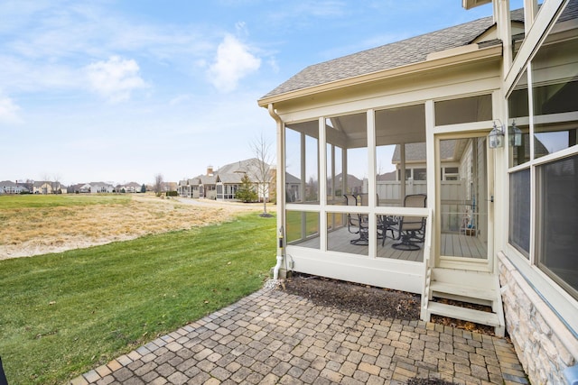 view of patio with a residential view and a sunroom