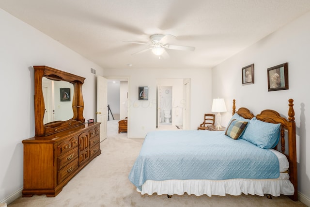 bedroom featuring ensuite bath, ceiling fan, baseboards, and light colored carpet