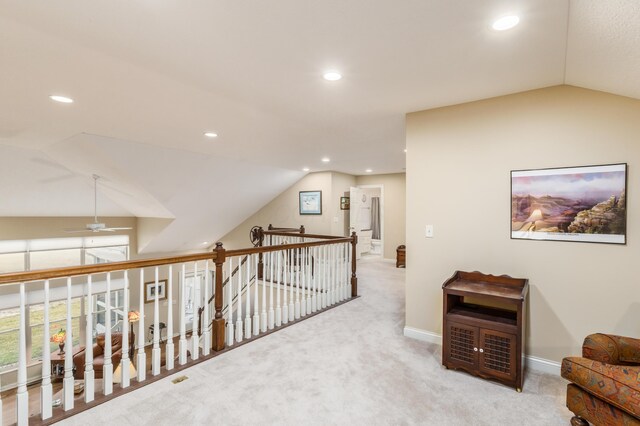 hallway featuring lofted ceiling, recessed lighting, carpet flooring, an upstairs landing, and baseboards