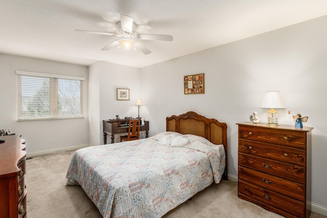 bedroom featuring a ceiling fan, light carpet, and baseboards