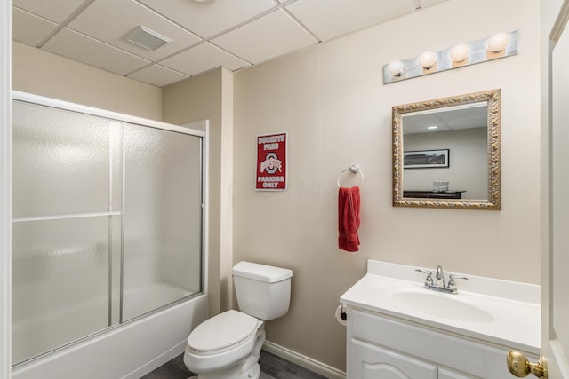 full bath with a paneled ceiling, visible vents, toilet, combined bath / shower with glass door, and vanity