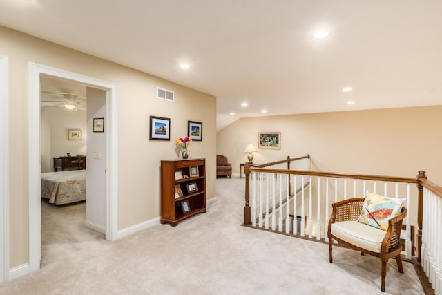 corridor with an upstairs landing, recessed lighting, visible vents, and carpet flooring