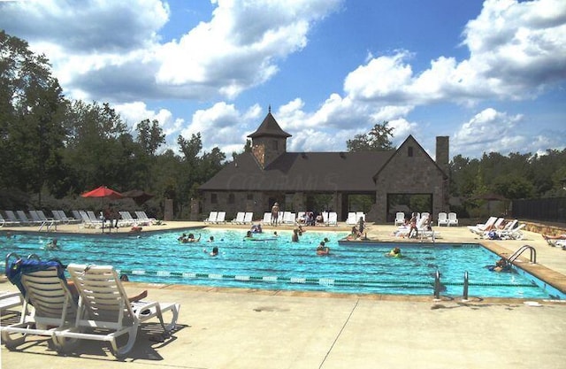 community pool with a patio area