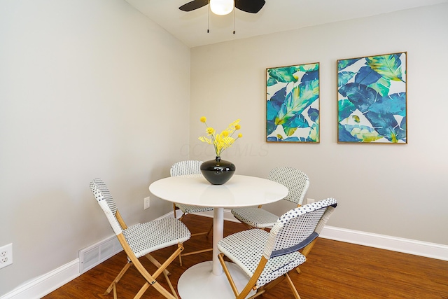 dining room with ceiling fan, wood finished floors, and baseboards