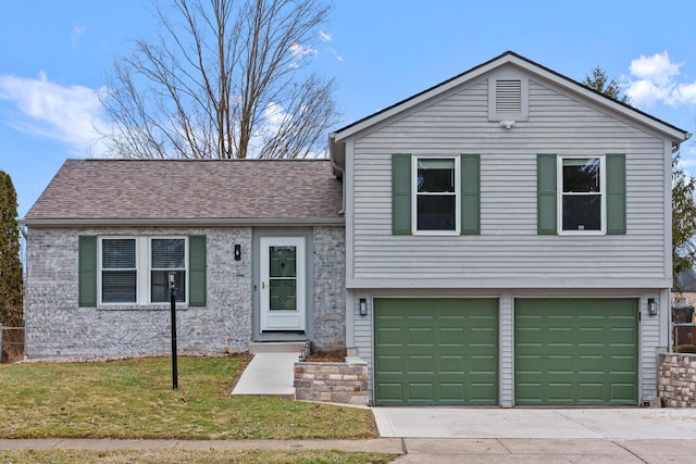 split level home featuring a garage and a front yard