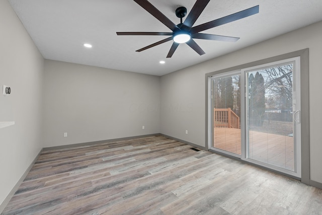 spare room with ceiling fan and light hardwood / wood-style flooring