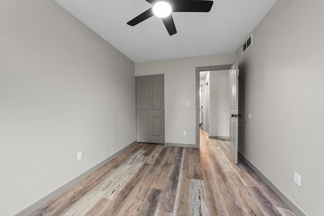 unfurnished bedroom with light hardwood / wood-style flooring and ceiling fan