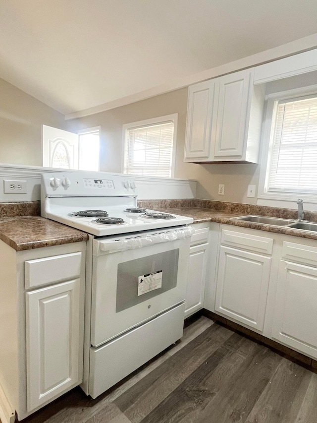 kitchen featuring white cabinetry, sink, dark hardwood / wood-style flooring, and white range with electric cooktop