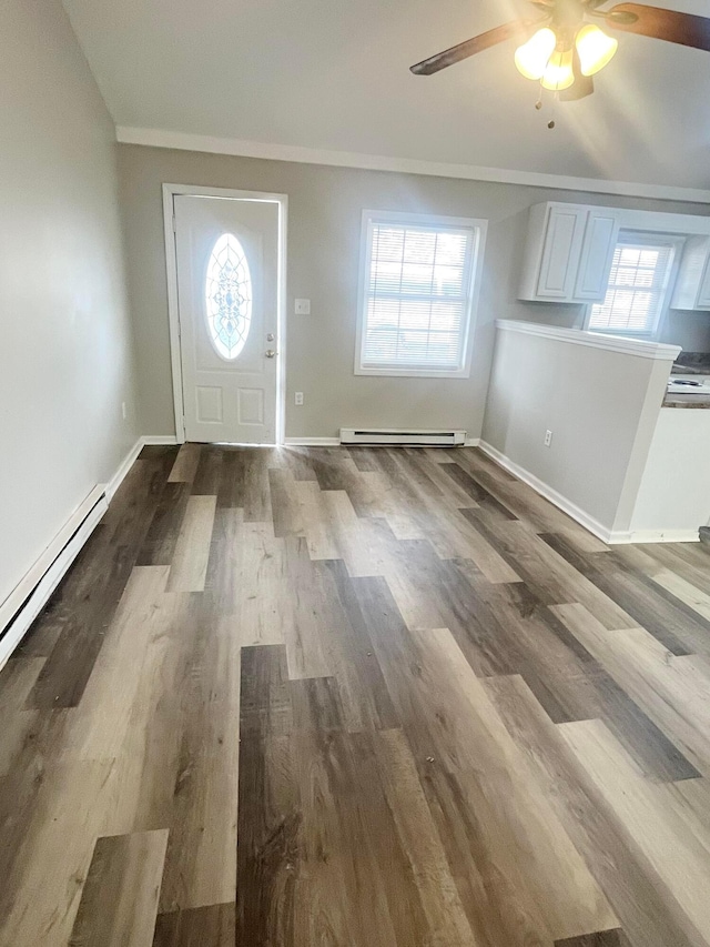 foyer featuring ceiling fan, hardwood / wood-style floors, and baseboard heating