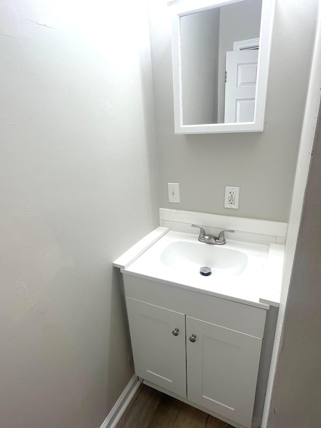 bathroom with vanity and wood-type flooring