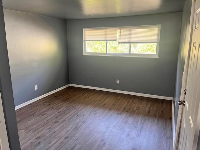 unfurnished room featuring dark hardwood / wood-style floors