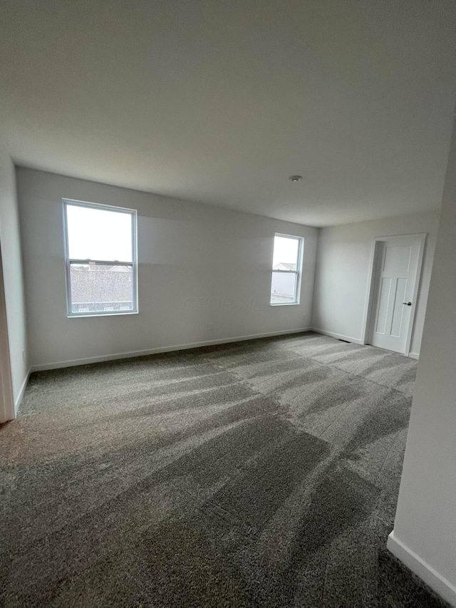 empty room with carpet flooring and baseboards