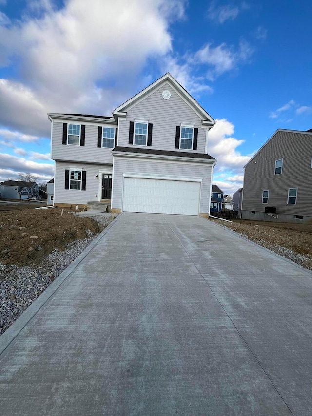 view of front of home featuring concrete driveway and an attached garage