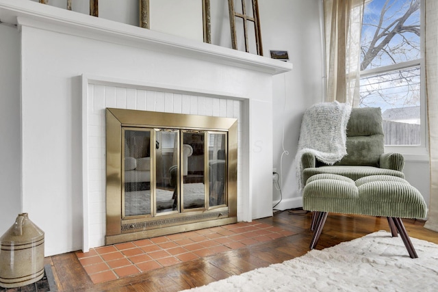 room details featuring a fireplace and wood finished floors