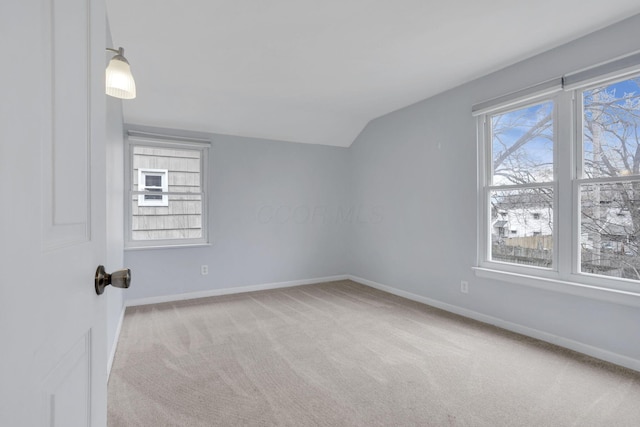 additional living space featuring carpet floors, baseboards, a wealth of natural light, and lofted ceiling