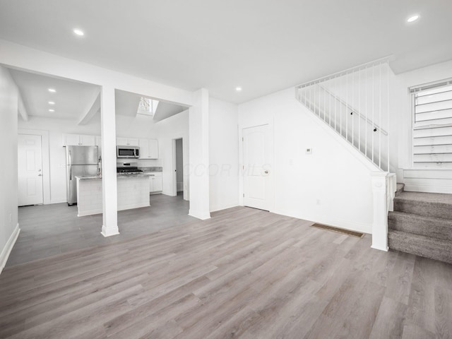 unfurnished living room featuring light hardwood / wood-style flooring