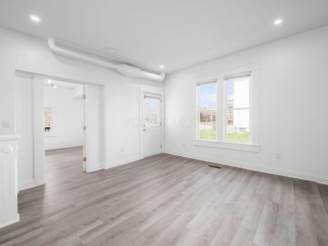 unfurnished room featuring light hardwood / wood-style floors