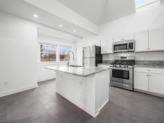 kitchen with white cabinetry, an island with sink, appliances with stainless steel finishes, and sink